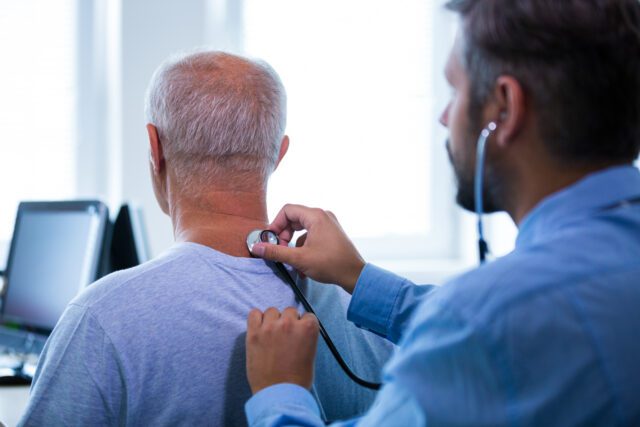 Male doctor examining a patient