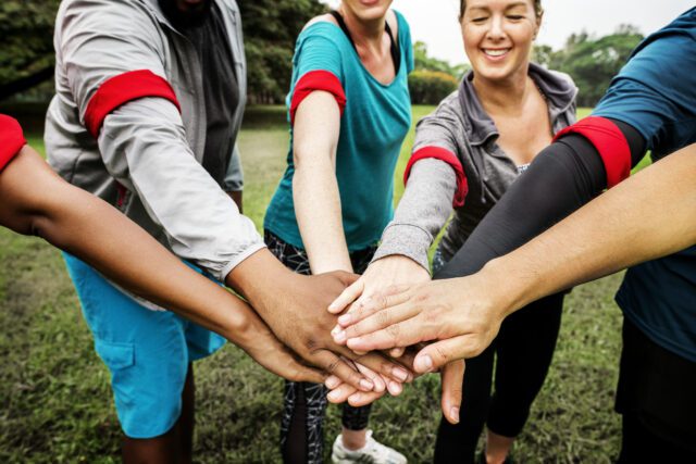 Diverse team stacking their hands