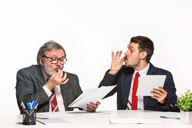 The two colleagues working together at office on white background.